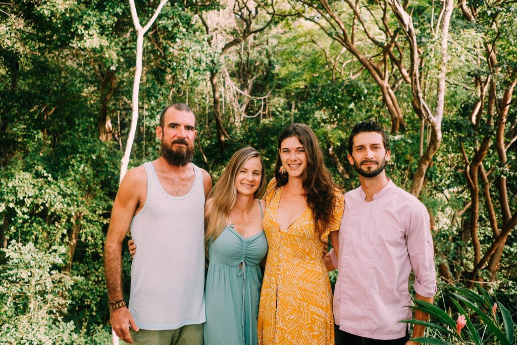 Ananda Lodge Retreat Center's team standing in front of the Costa Rica jungle.