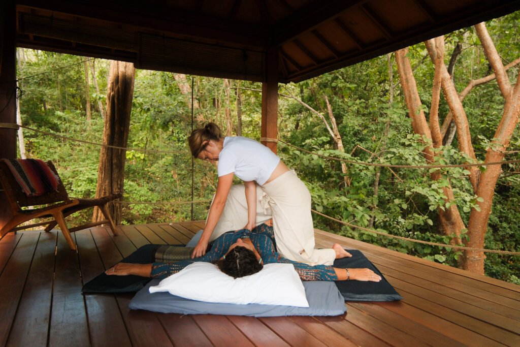 A retreat guest receiving a message in the healing hut surrounded by Costa Rica's jungle.