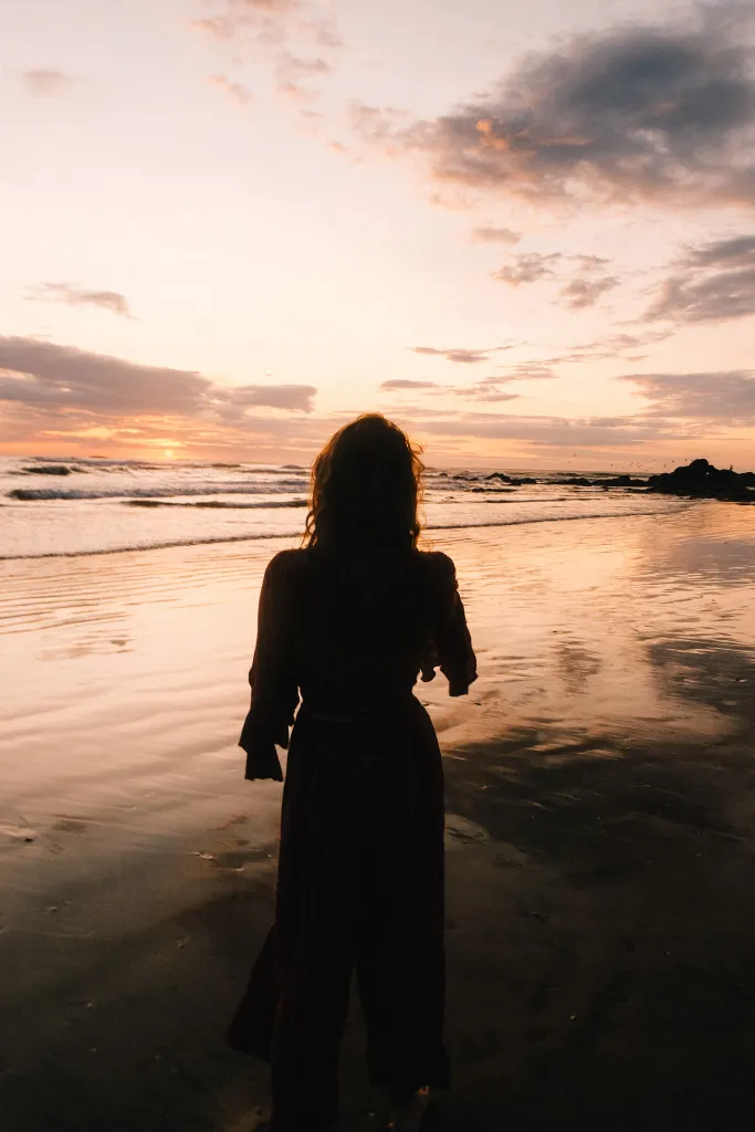 A retreat participant reflects during sunset, embodying the peaceful transformation of somatic healing retreats in Costa Rica.