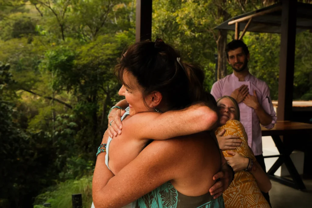 Two participants hugging after a San Pedro ceremony, embodying emotional release, connection, and healing through Huachuma
