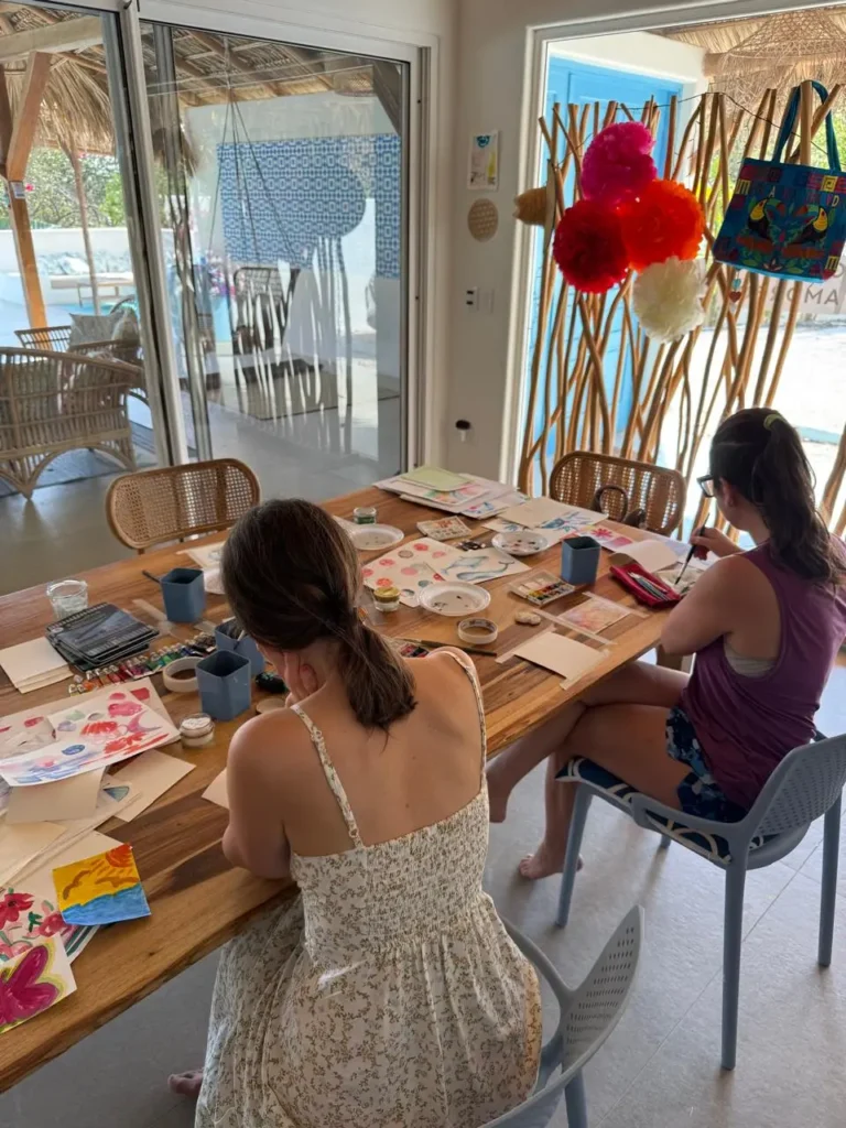 Two women participating in art therapy after their plant medicine ceremony at Ananda Lodge.
