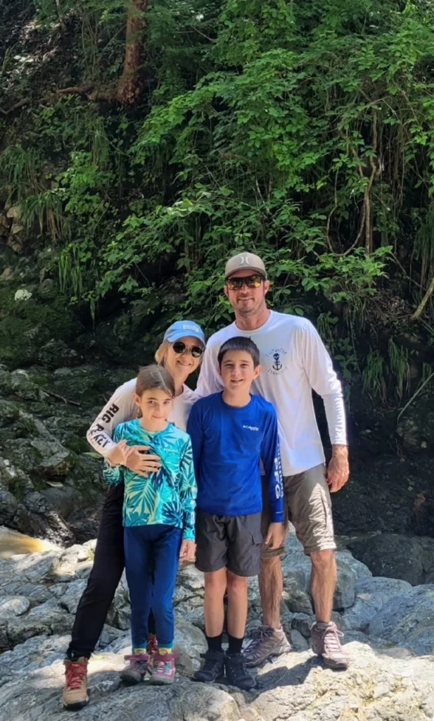 Family embracing in Costa Rica after sharing heartfelt ayahuasca experience stories at a plant medicine retreat center