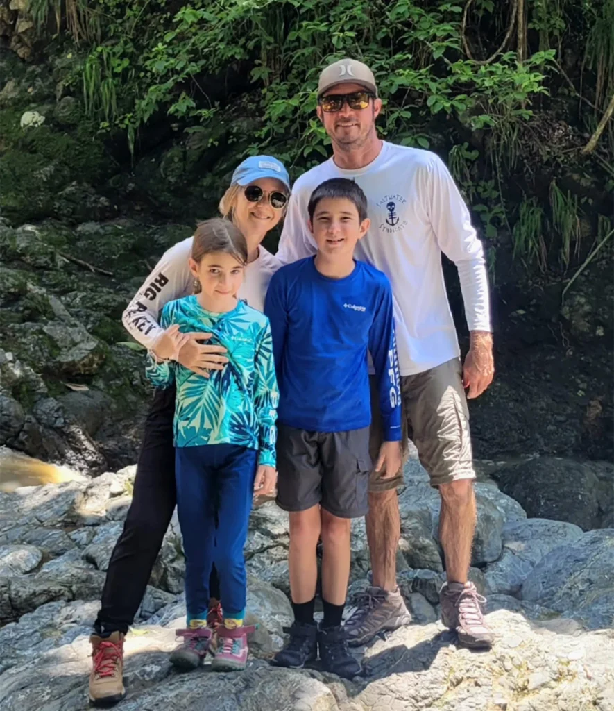 A mother, father, and their two children smiling at Ananda Lodge.
