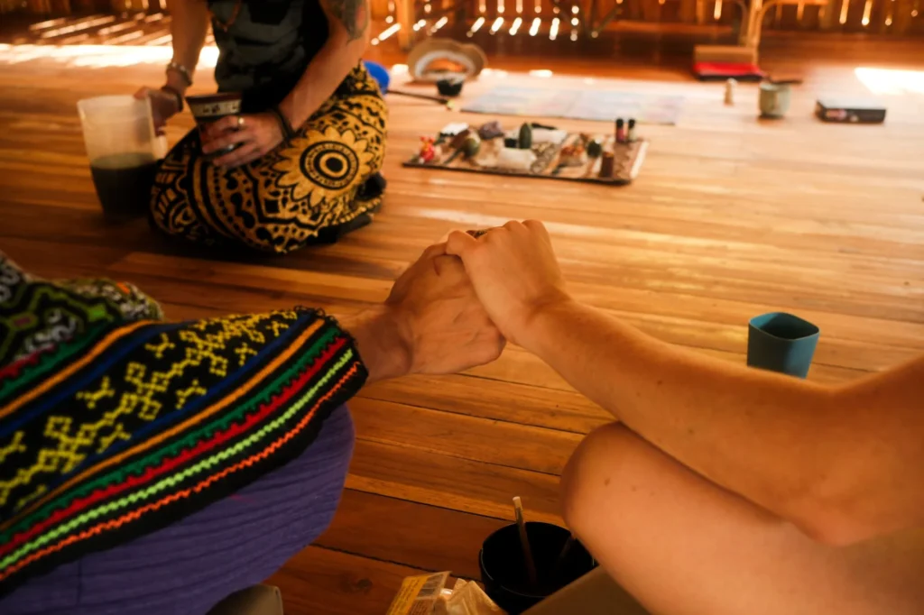 Two people holding hands feeling connection, intention, and shared purpose while preparing to host a retreat