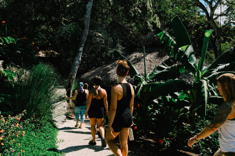 retreat guests entering healing temple in costa rica jungle before beginning to enter into plant medicine ceremony, embodying mindfulness and awareness